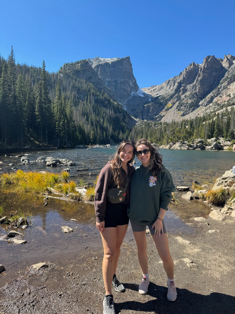 Hiking by an alpine lake with a friend