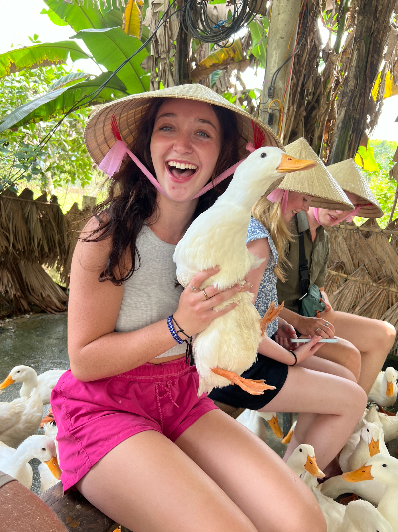 Holding a duck on a farm visit in Vietnam
